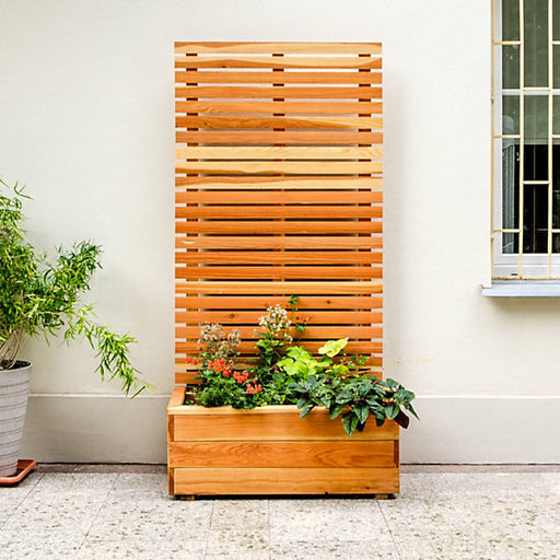 Jagram Larix larch planter with horizontal slatted screen in a planted patio setting